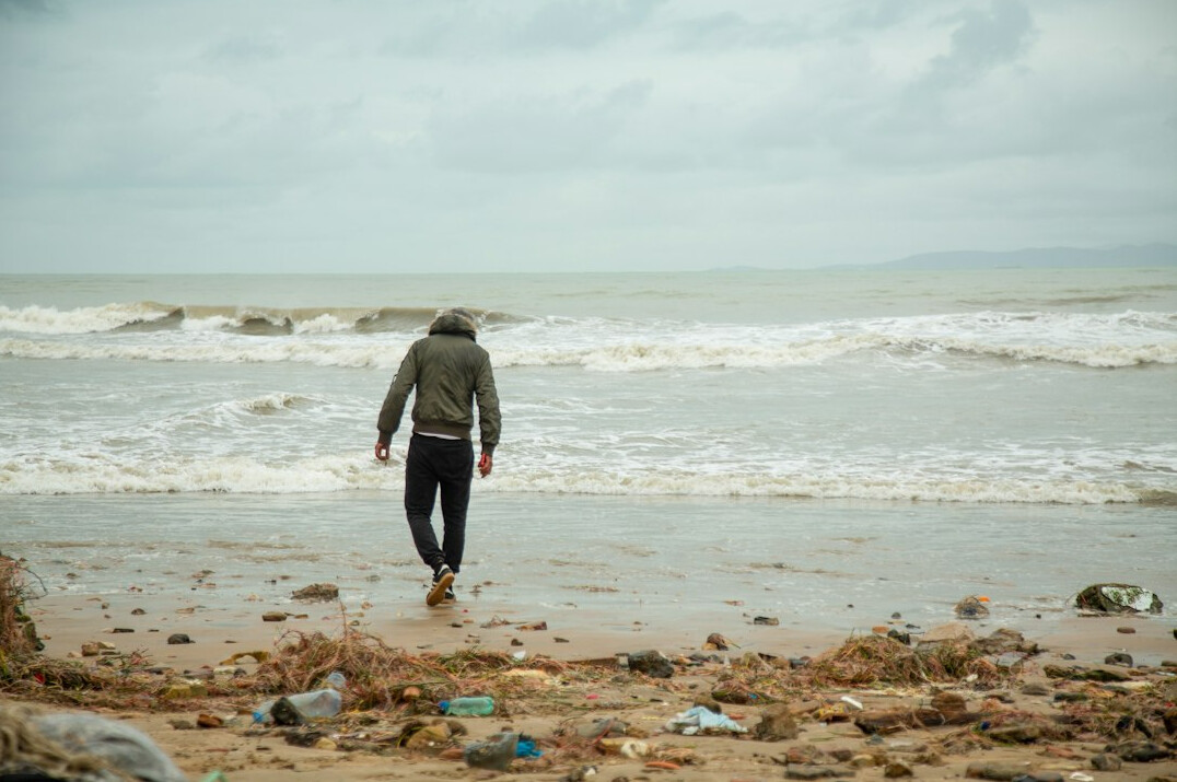 person walking in heavy rain