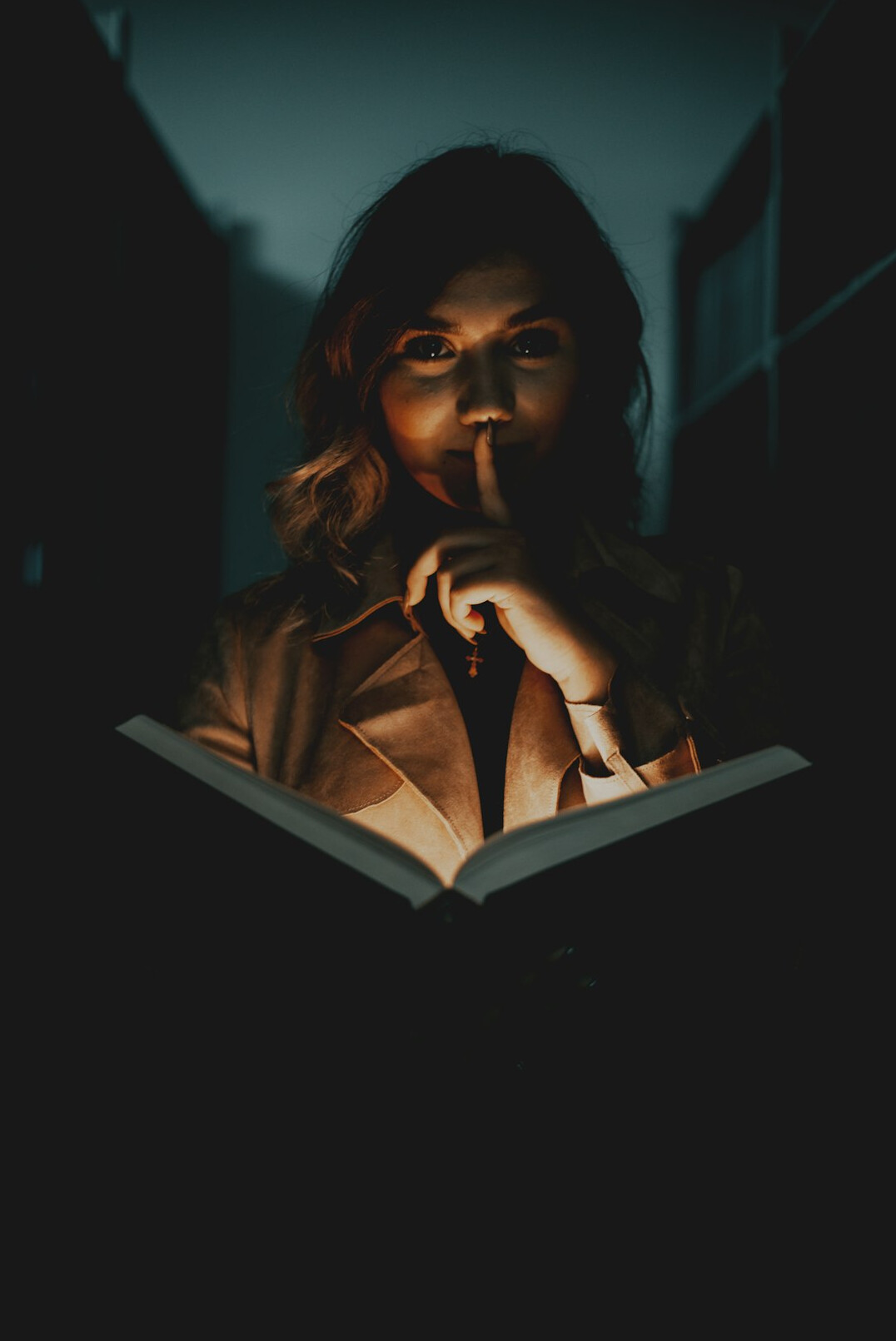 woman reading book at night