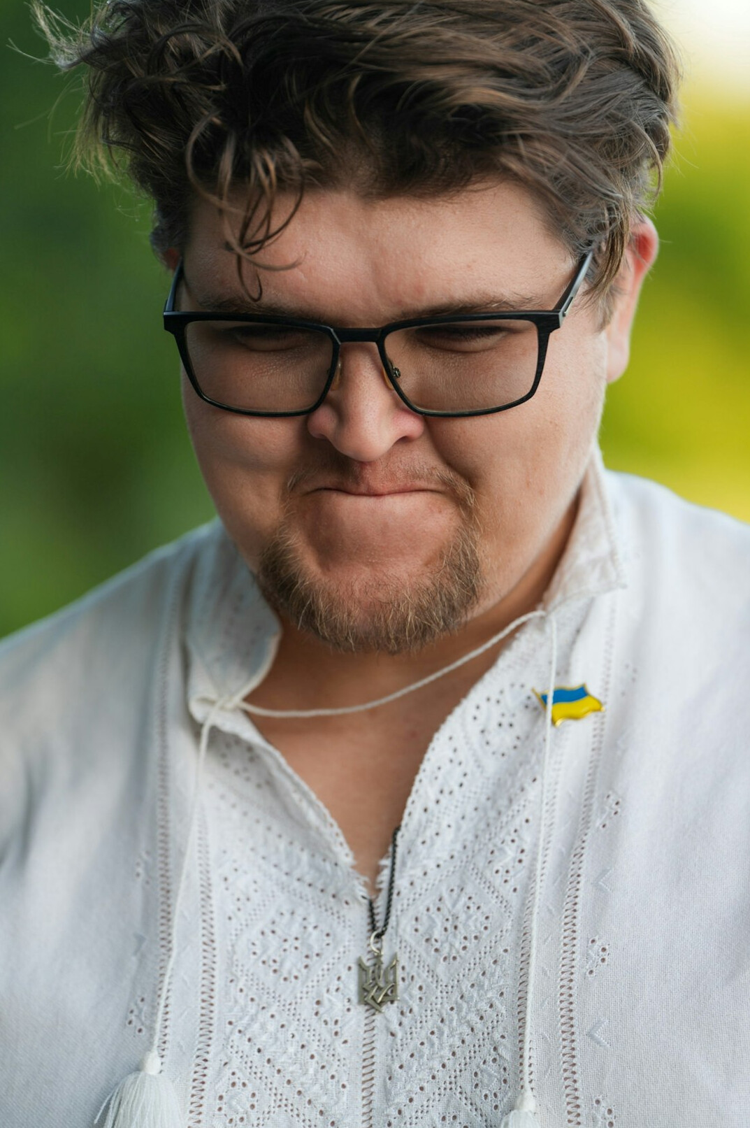 Studio portrait of a Croatian man in his thirties, proofreader, round glasses, sweater