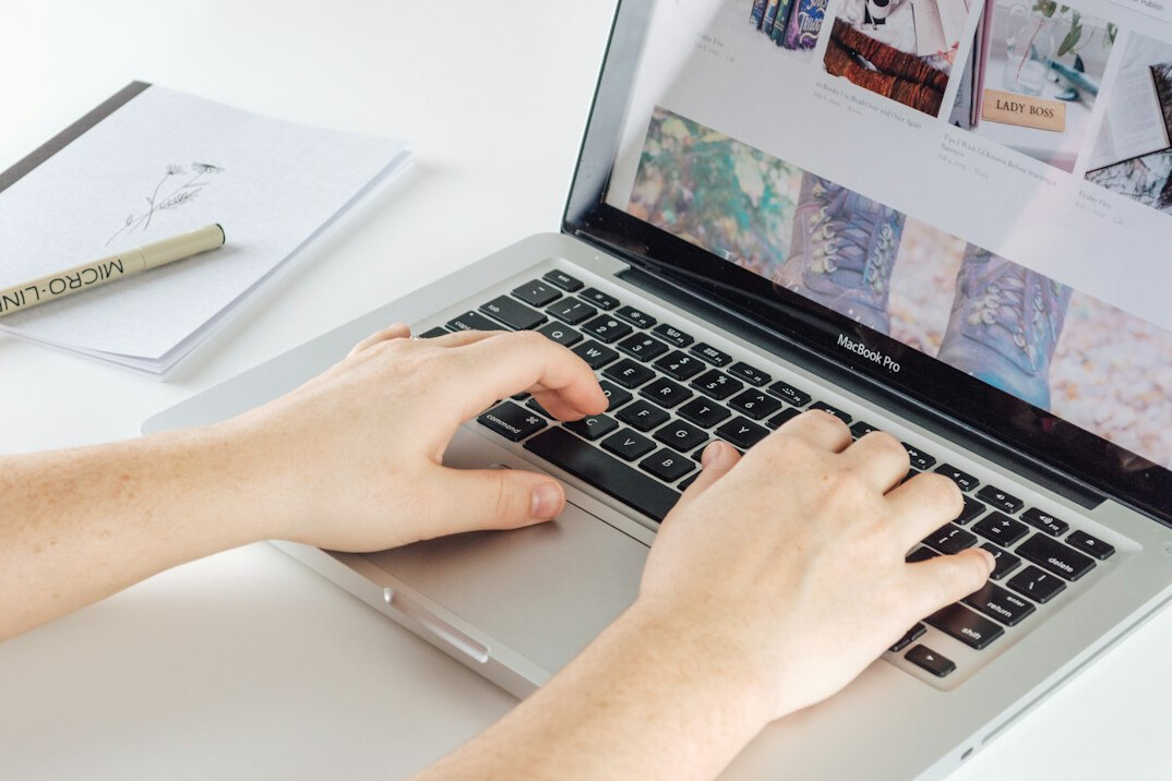 writer typing on laptop at desk